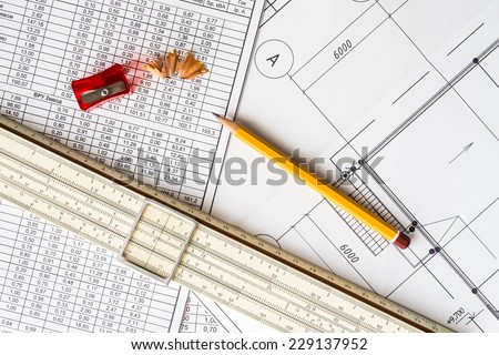 Architectural drawings, slide rule and a sharpener with a pencil