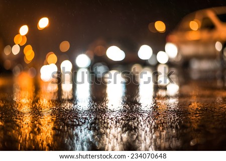 City night headlights, car rides at the rain through the night city