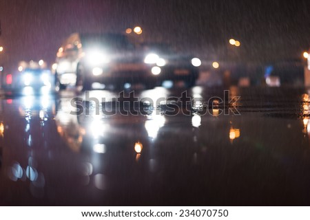 City night lights, car rides at the rain through the night city