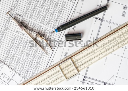 Slide rule with diagrams and drawing tools on the table