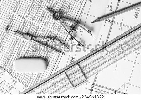Slide rule with diagrams and drawing tools on the table