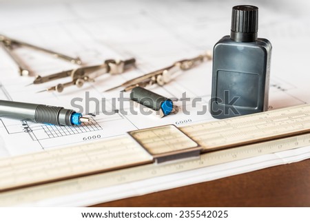 Slide rule with diagrams and drawing tools on the table. Angle view