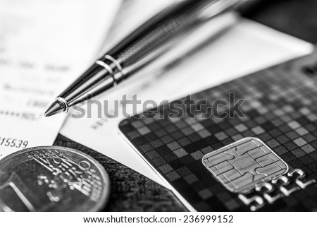 Pay the bills, credit card with pen and money on the table