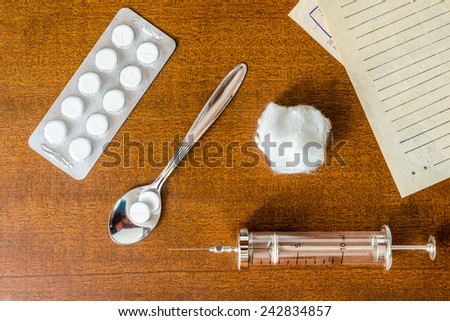 Prescription for the treatment of the disease, syringe injection and prescriptions from the doctor with a tablets on the table. Top view