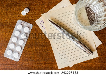 Cure the disease, prescribe the right tablets, recipe and pen with a tablets on the table