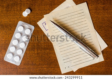 Cure the disease, prescribe the right tablets, recipe and pen on the table