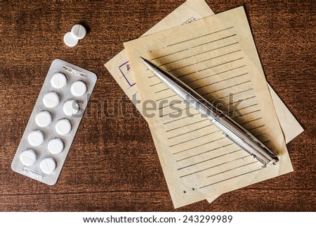 Cure the disease, prescribe the right tablets, recipe and pen on the table. In the old tones