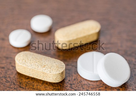 Cure the disease, take the pills and vitamins on the table. Angle view