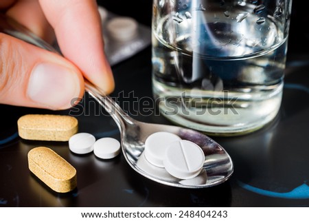 Take tablets, X-rays with pills and vitamins with a glass of water on the table