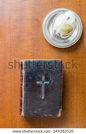 Candle and Bible on the wooden desk
