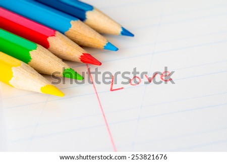 Word love written in a notebook with colored pencils