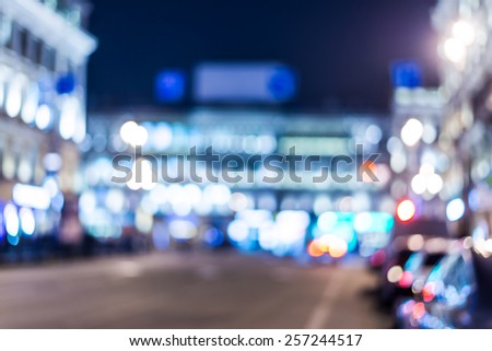 Night city, night life on the streets, the buildings in lights in the background. In blue tones