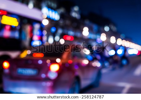 Nights lights of the big city, cars at night with pedestrian on the avenue. In blue tones