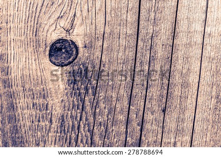 Old cracked wood with knots and cracks. Image in the orange-blue toning