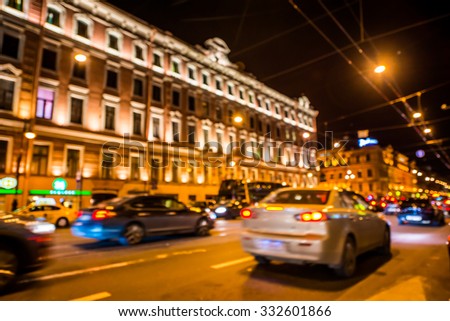 Nights lights of the big city, rush hour in the city. Wide-angle view, defocused image