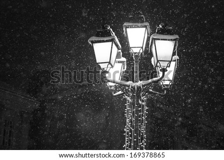 Snowing urban landscape with city lights in the night in Timisoara, Romania