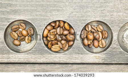 Fresh coffee beans in striped wood texture with circles carved in