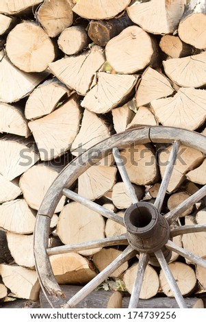 Details from a traditional, romanian wooden wheel with wood sticks in the background