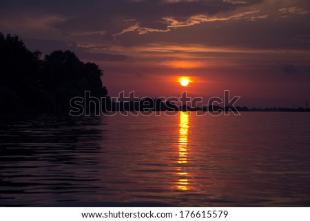 Beautiful sunset in Sulina harbor, Danube Delta, Romania. Image has a pleasant grain texture visible on its maximum size
