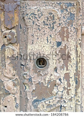 Abstract composition from a wooden painted old door with metallic lock