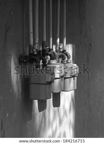Black and white measuring gas pressure devices and concrete wall background