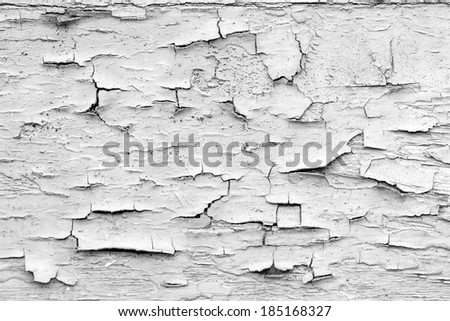 Black and white photography of wooden surface painted in beautiful colors and shapes with partly peeled paint