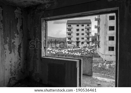 Black and white abandoned block of flats under construction. Brick and cement textures. Details from inside