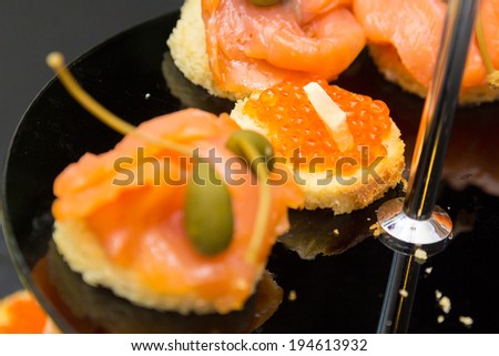 Appetizers with salmon and orange fish spawn