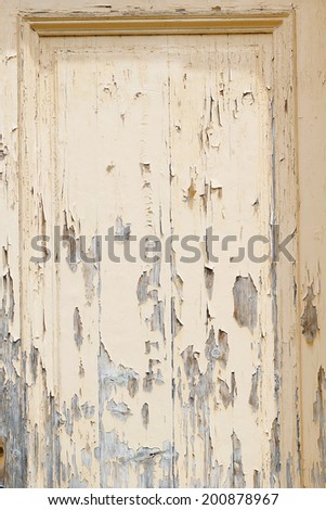 Abstract composition from a wooden painted old door with metallic lock