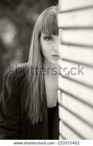 Black and white portrait of a beautiful, caucasian, young, long haired woman posing in urban locations