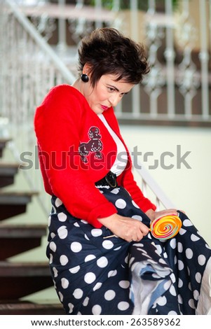 Photo session of an expressive,short haired brunette woman with lollipop