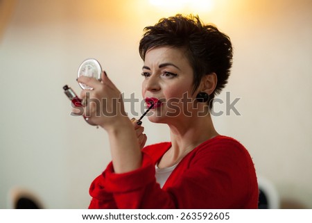 Photo session of an expressive,short haired, brunette woman during the makeup session