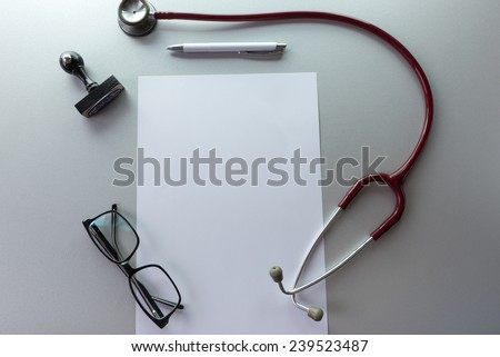 Doctor\'s desk desk medical concept with a copy space on the paper.