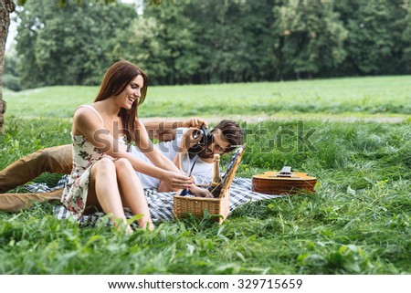 Shot of a happy young couple having romantic time and enjoying a summer picnic. Natural light, selective focus.
