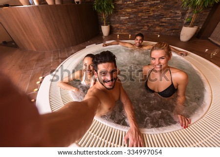Wide angle shot of a man making selfie with friends at the spa.