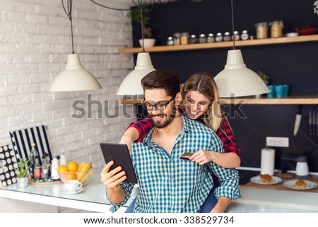 Shot of a women holding a credit card and purchasing online.