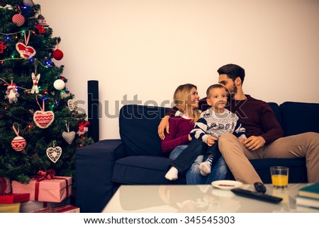 Shot of a beautiful happy family sitting on a sofa in living room.