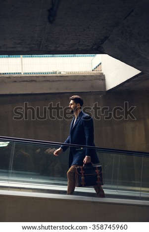 Shot of a man carrying bag and heading up to the office.