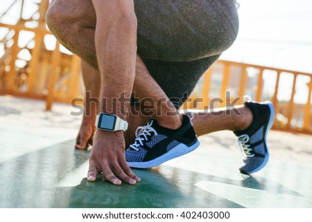 Male runner about to start a training session.