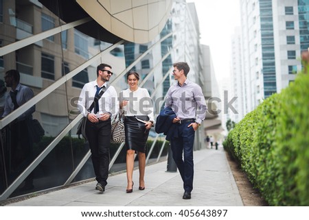 Elegant businesspeople walking in a modern city.