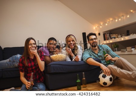 Group of friends enjoying football match together.