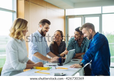 Group of business colleagues working in a boardroom meeting.