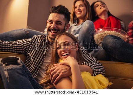 Group of friends enjoying movie time at home.