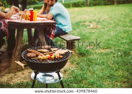 Friends enjoying barbecue time in the nature.