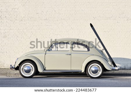 MUENSTER, GERMANY - MARCH 3, 2011: Early 60s VW Beetle, or informally the VW Bug, with ski rack parked in a street. The VW Beetle manufactured and marketed by German automaker VW from 1938 until 2003.