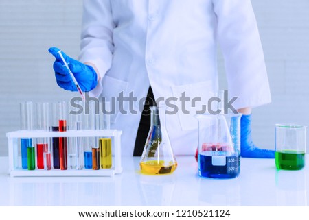 The scientist test new product by test tube.