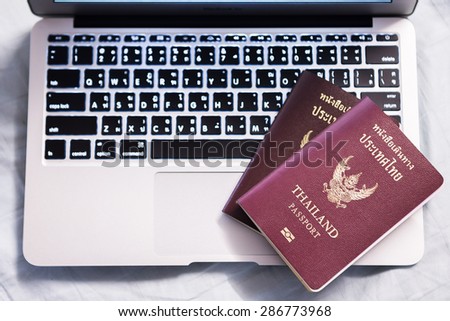 Thailand passport with laptop, Find travel information