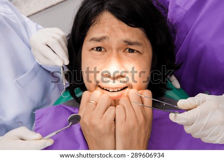 Man suffering from toothache, Man frightened dentists covers her mouth