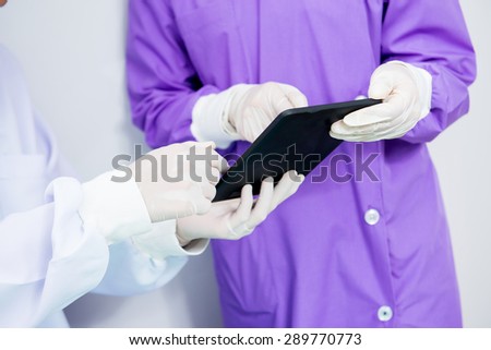 Virus Mers, Medical Scientist Reading Internet Pages About MERS Virus on Digital Tablet Computer