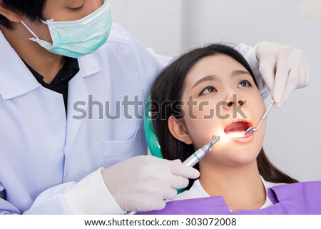 Medical treatment at the dentist office, Dentist and his assistant carrying out a thorough examination